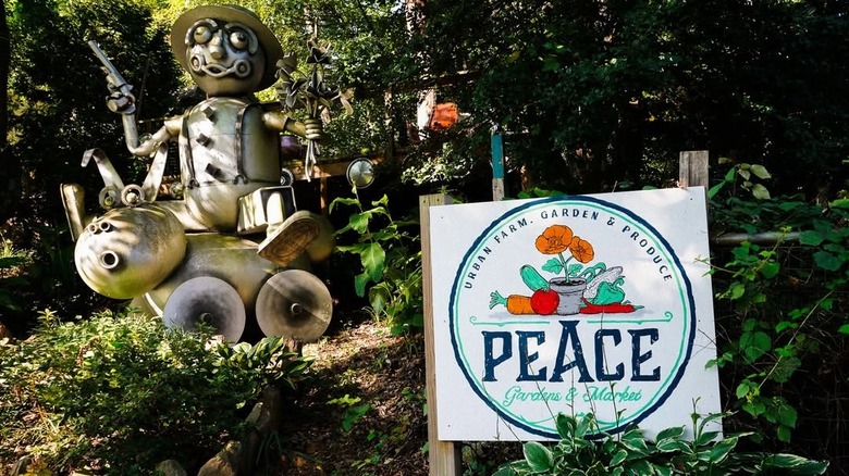 Metal art installation and Peace Gardens sign