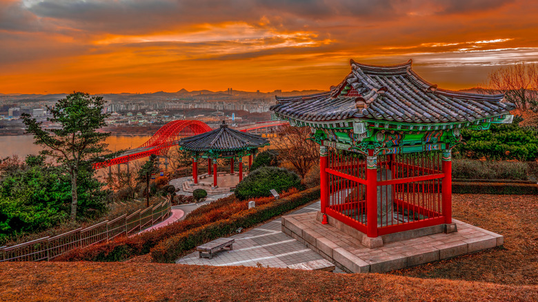 An aerial view of HaengjuSanseong showing the Han River and Banghwa Bridge at dusk in Goyang, South Korea.
