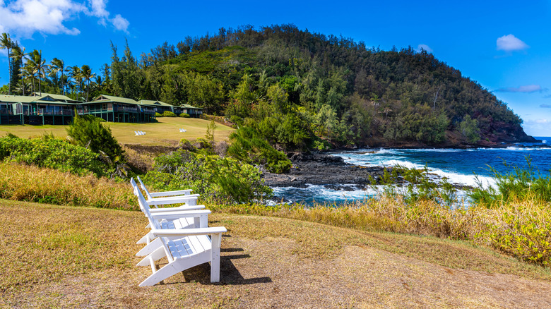 White chairs overlooking the ocean at Hāna-Maui Resort