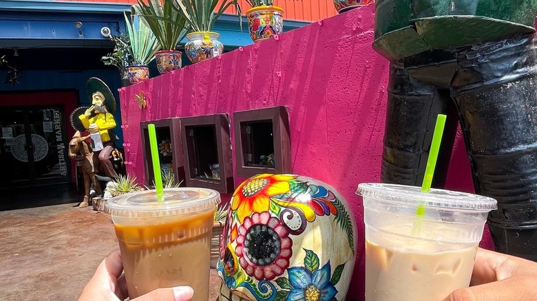 Toasting iced coffees in ADios Cafe's patio