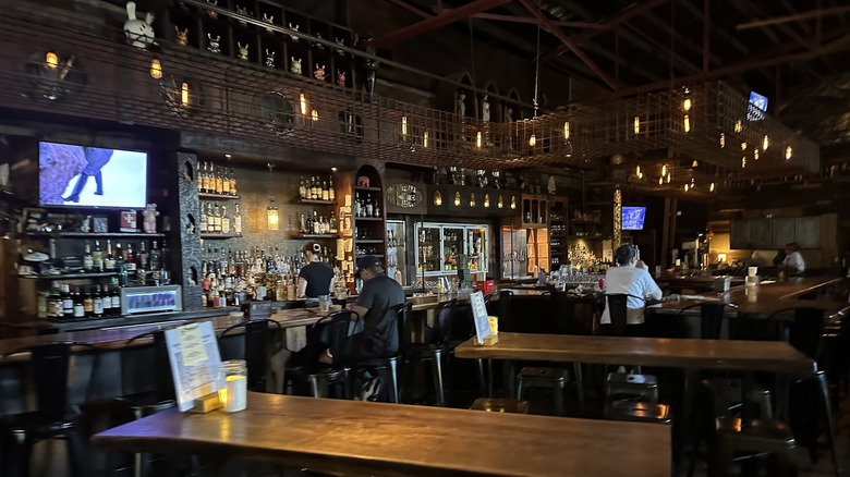 Inside Argosy, with a bar, long tables, and customers