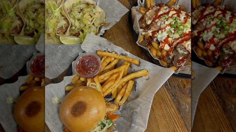 A variety of dishes from Hankook Taqueria on a wooden table