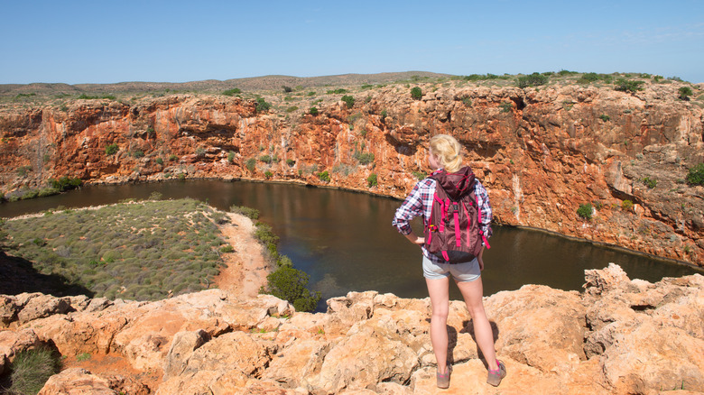 Woman hiking in Outback Australia, overlooking Yardie Creek river in Cape Range National Park