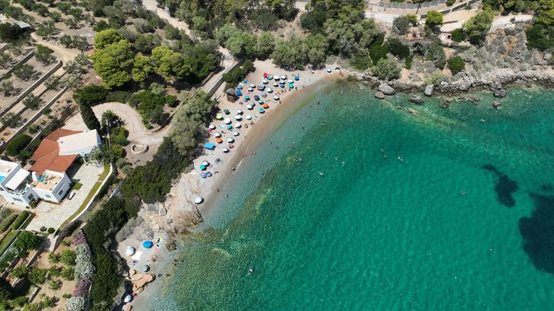 A bird's-eye view of Erotospilia Beach with clear waters and rocky coastline