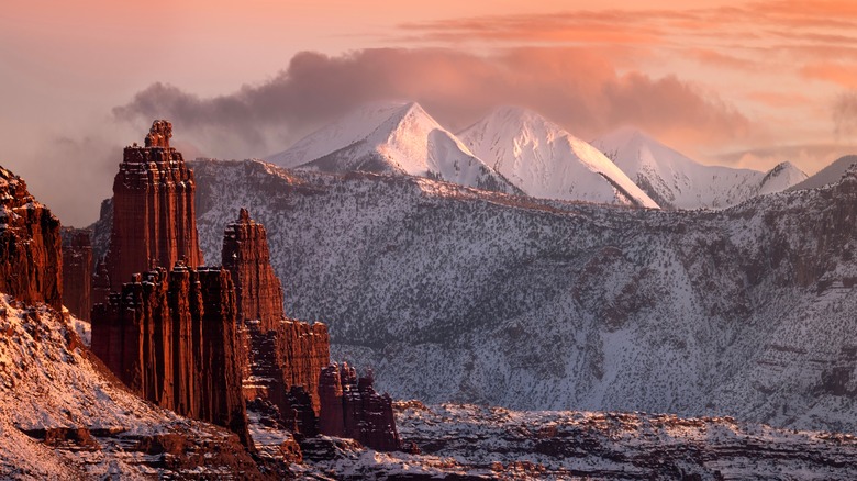 The Fisher Towers in winter against snowy Utah mountains