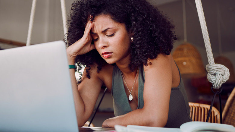 Stressed woman using laptop