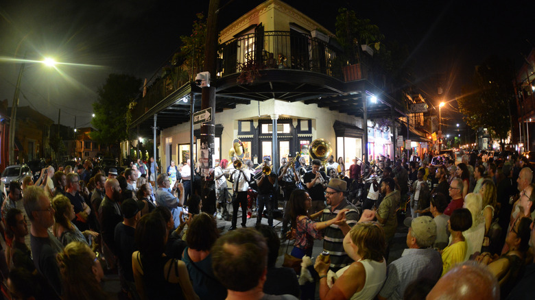 A band plays on the corner of Frenchmen Street to a large crowd