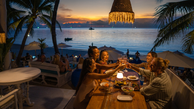 Group of friends at resort hotel enjoying dinner