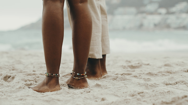 Couple with toes in sand at beach
