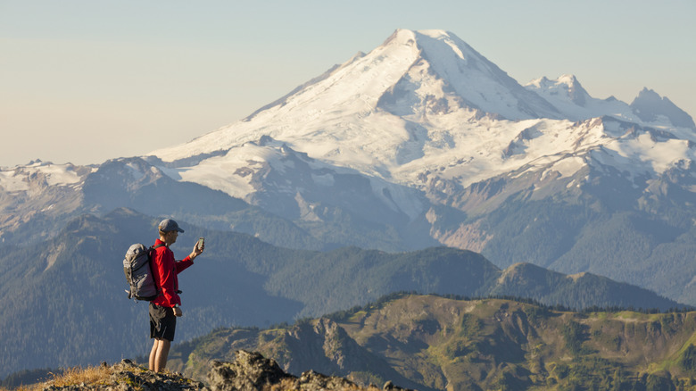 Hiker taking a photo of Mount Baker