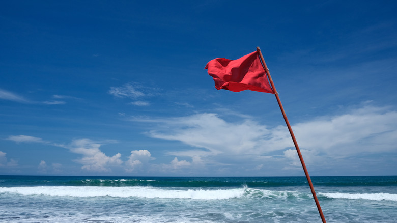 A red beach flag warning of hazardous conditions at Ponce Inlet, Florida.