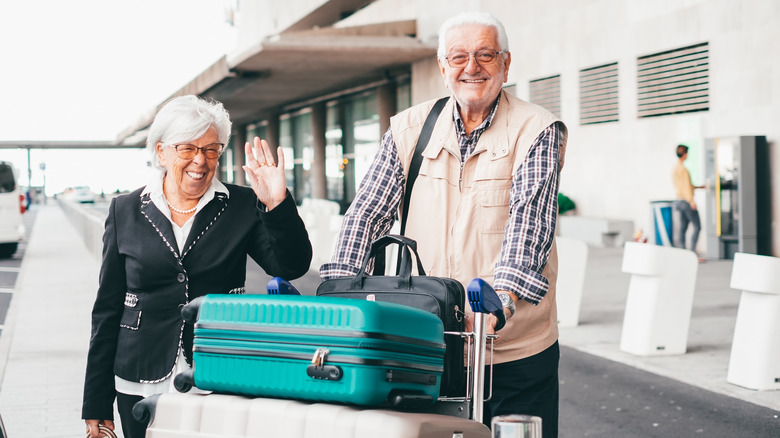 Boomer couple with a large suitcases