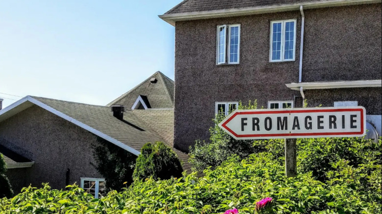 A sign reading "Fromagerie" points the way to La Famille Migneron de Charlevoix in Baie-Saint-Paul, Quebec