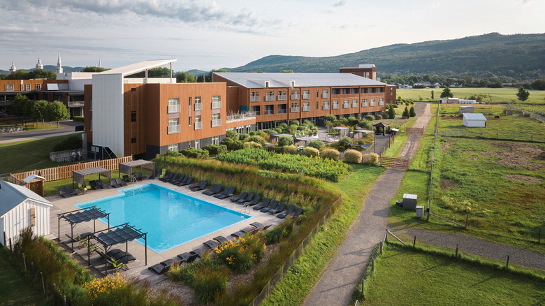 The outdoor pool surrounded by farmlands at sunset, at Hotel & Spa Le Germain Charlevoix in Baie-Saint-Paul, Quebec