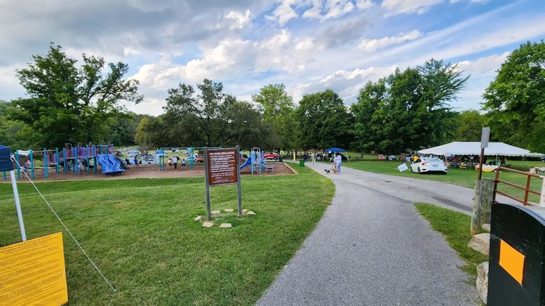 A small gathering at a local park in Woodlawn, Maryland, featuring tents, green spaces, and a playground.