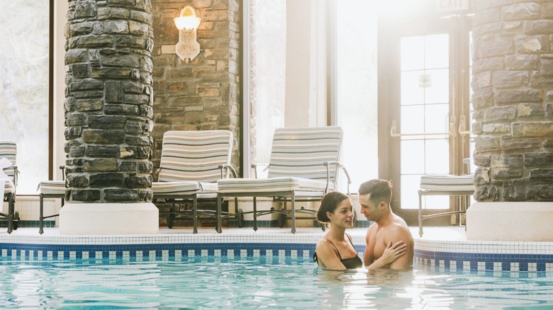 Couple in the indoor pool at Fairmont Banff Springs spa