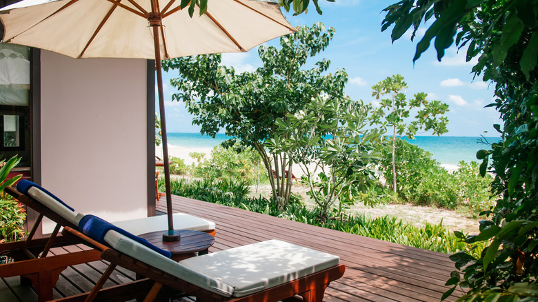 Chairs on a deck overlooking Bakantiang Beach in Koh Lanta, Thailand.