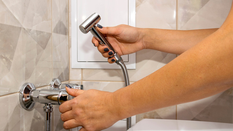 Hand reaching for a bidet