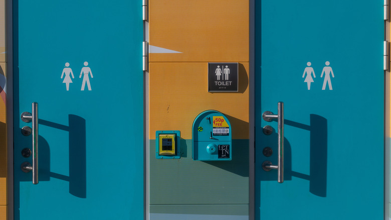 Blue toilet doors with pay-per-use machine