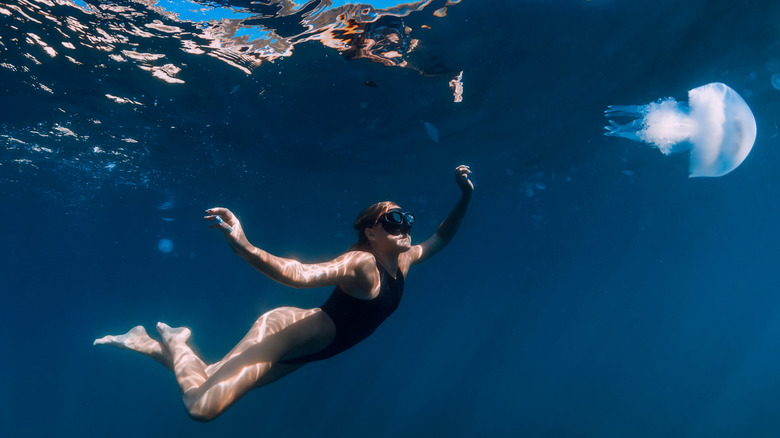 Woman swimming under water