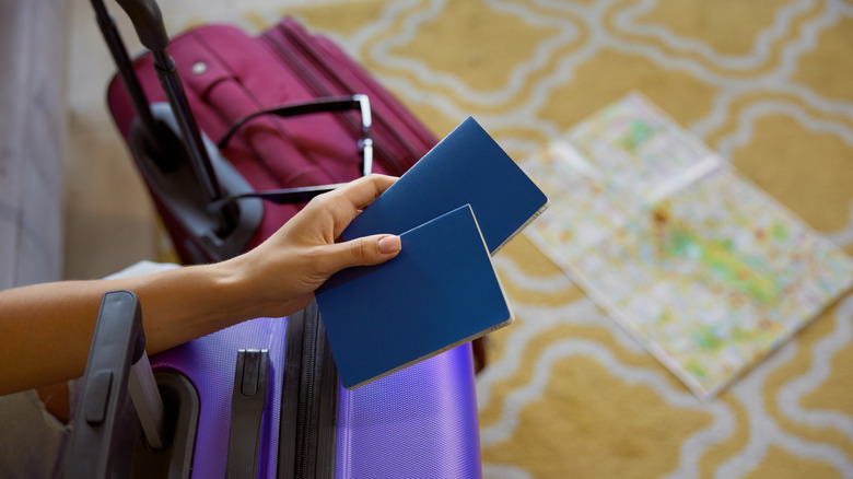 Person holding two passports