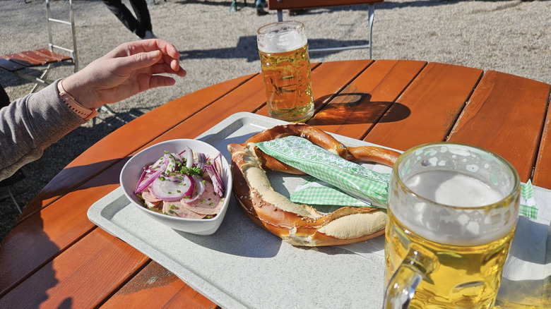Food and beer on a table at Zum Flaucher Biergarten in Munich