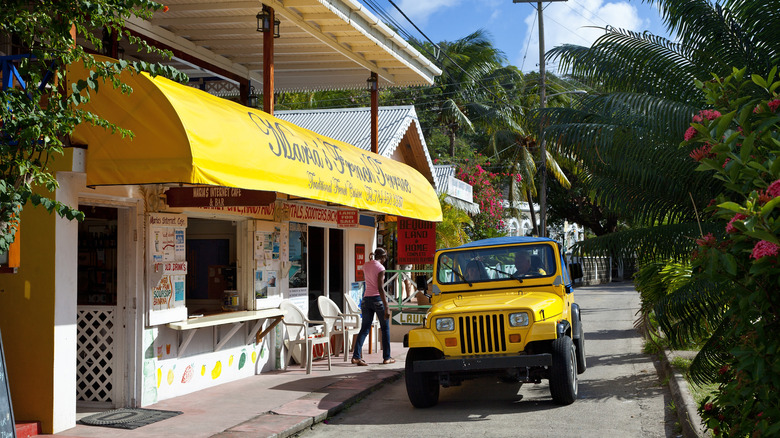 A yellow jeep in front of a store in Bequia
