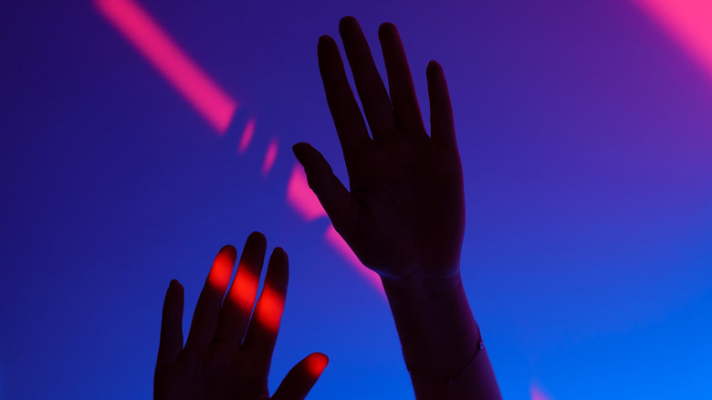 Hands free of phones, hands in the air dancing in a Berlin nightclub