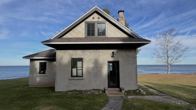Small weathered house with Lake Superior in the background