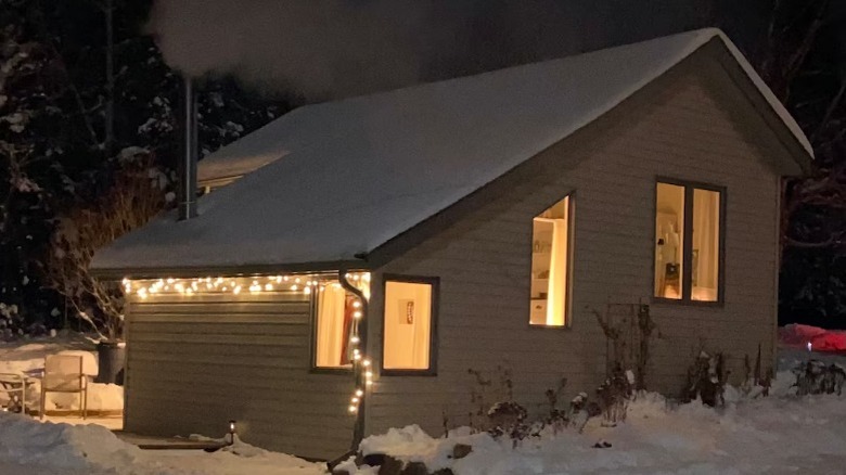 Cabin looking out onto frozen lake at night