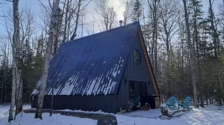 Aframe cabin covered in snow