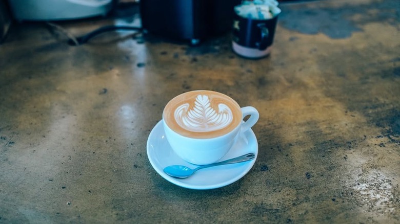 Latte with latte art on worn counter