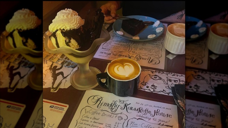 Coffee and an ice cream sundae on a table with menus