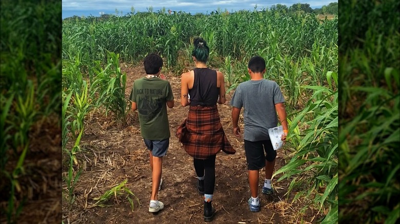 A mom and two kids walking through the Graff 7A Ranch Corn Maze in Hondo, Texas