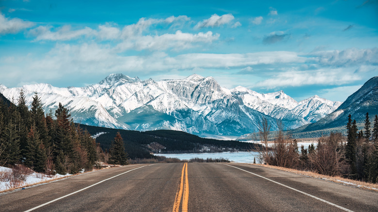 Roadway towards snow-capped mountains
