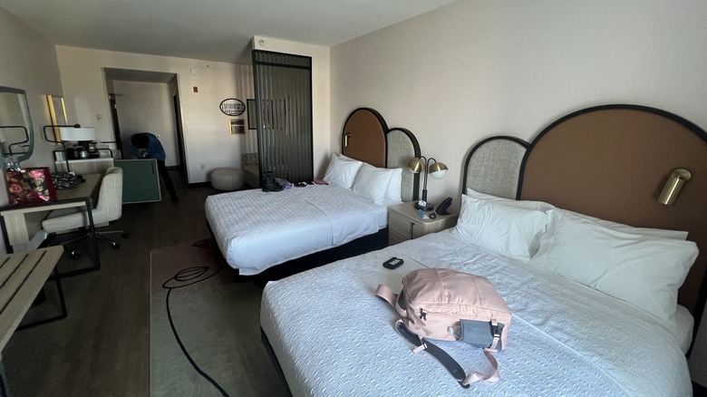 Interior view of modern, boutique-style hotel room in cream, black, and neutral palette at Hampton Inn Tampa Fairgrounds Casino