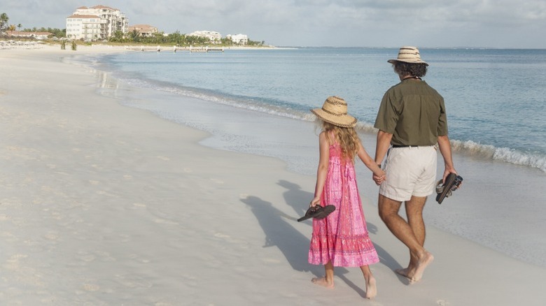 Mother and daughter walking on Grace Bay Beach in Turks & Caicos