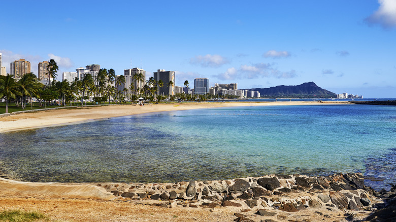 View of Diamond Head in the distance, Ala Moana Beach Park in the foreground with crystal clear ocean waters