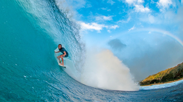 Big wave surfer riding the barrel in a wave at Waimea, the North Shore of Oahu
