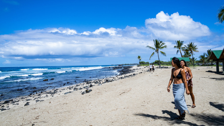 women walking on beach