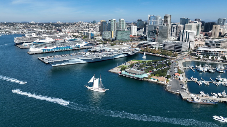 An overhead shot of San Diego and its waterfront with sailboats in the water and cruise ships docked and buildings in the background