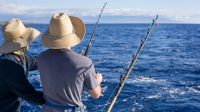 two people fishing in ocean