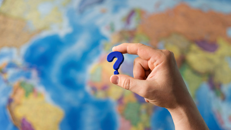 A question mark above a world map