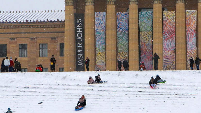 People sledding down the steps of the Philadelphia Art Museum
