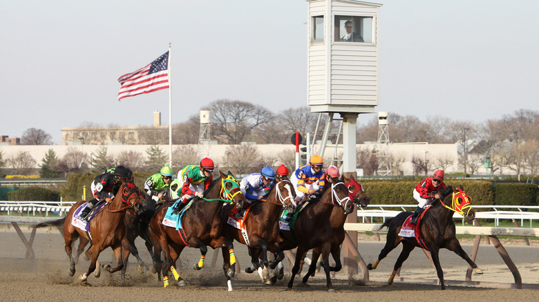 Equestrians racing at the Aqueduct Racetrack in Queens, New York