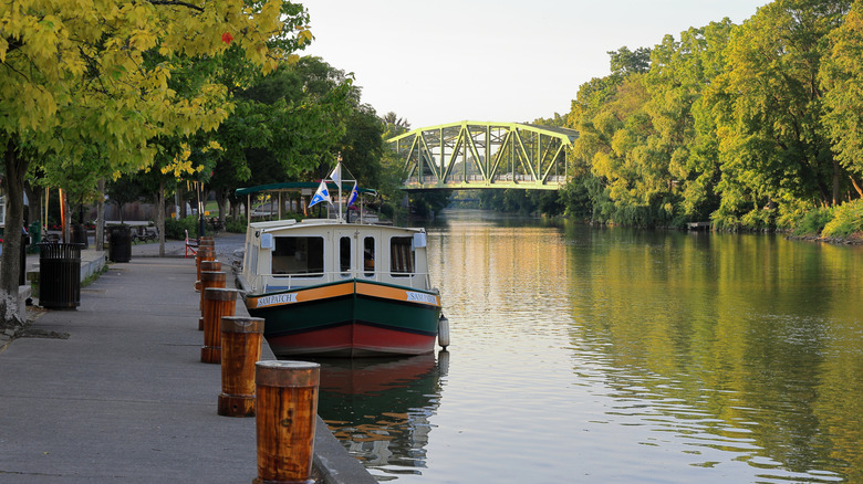 A tour boat on the Erie Canal with a bridge in the background
