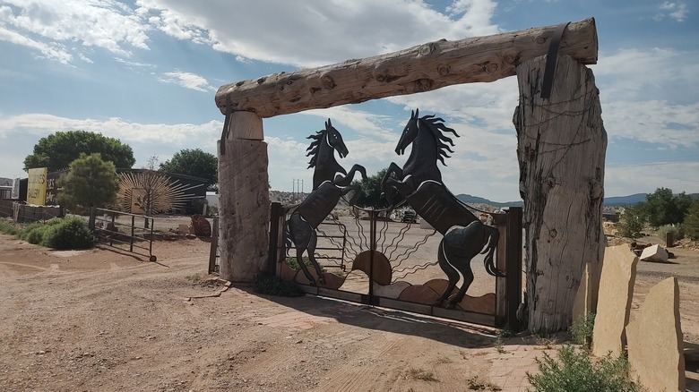 A gate with ornate horse sculptures near San Felipe Pueblo