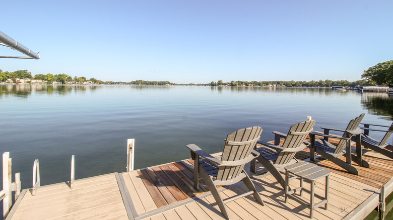 Wooden chairs on a deck overlooking Lake Fenton.