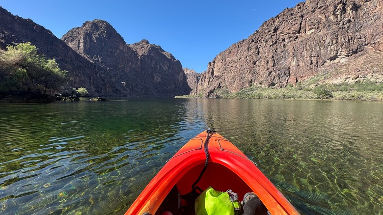 The bow of an orange kayak heading down the Black Canyon Water Trail