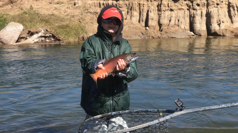 A boy holding a fish at Spinney Mountain State Park